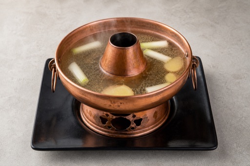 Photorealistic aromatic Beijing copper pot clear broth hot pot broth P02 food image by VDAMO